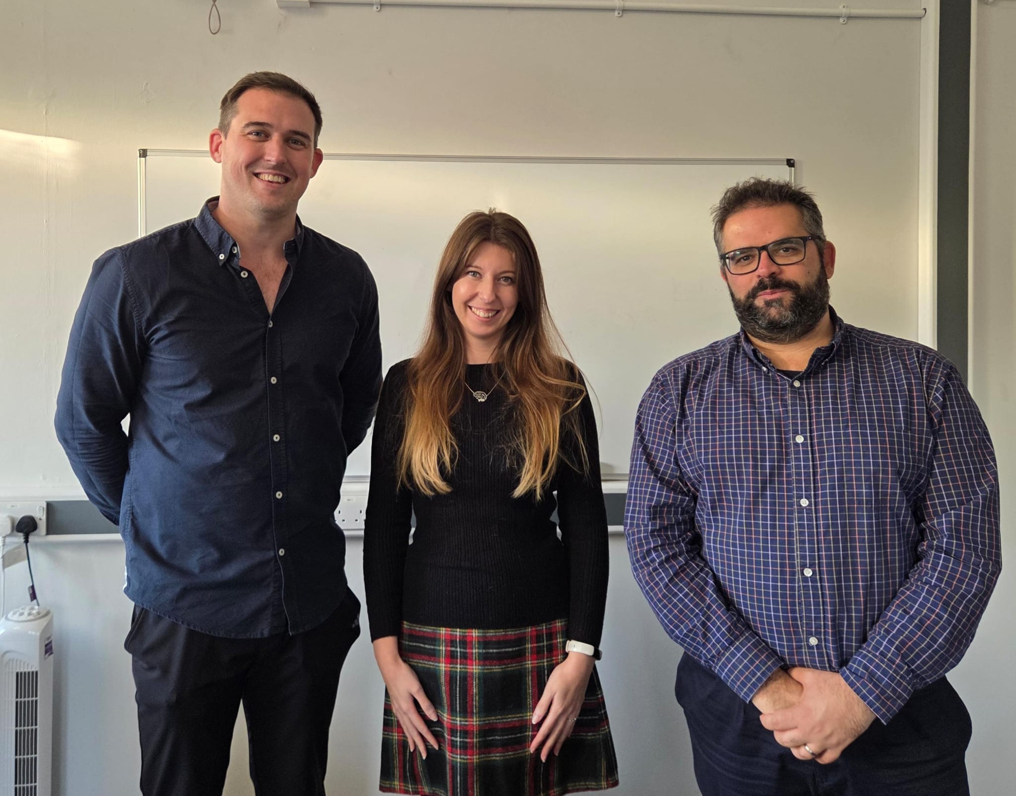 Charlotte, standing between her two examiners - Alex and Adam. All smiling.