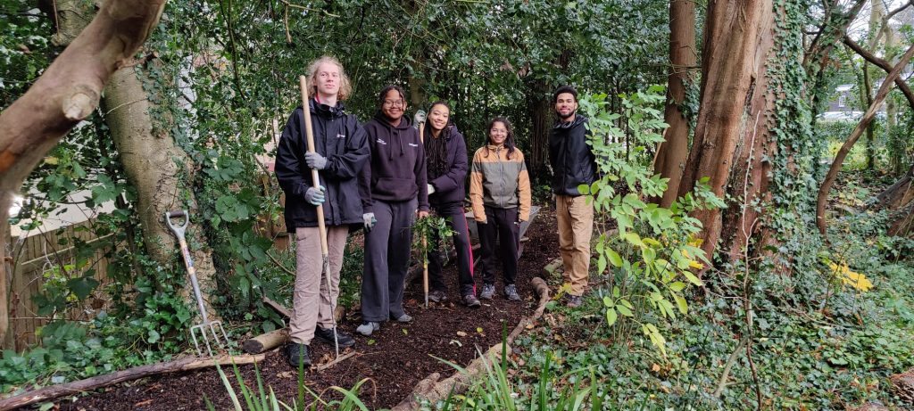 The wonderful group of volunteers who helped out with the woodland walk, standing proudly in their newly made path.