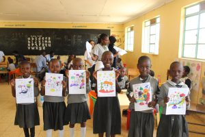 Students holding up drawings from the session