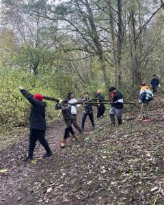 Students working together to clear trees