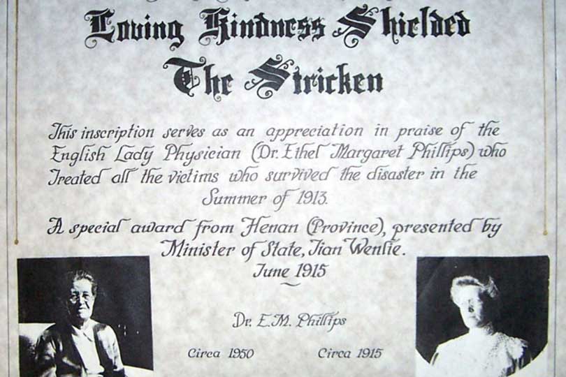 Black-and-white award certificate inscribed with recognition of Dr Ethel Margaret Phillips’ medical work, featuring decorative text and two small portrait photographs of her from different stages of life.