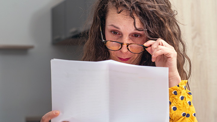 A patient looking puzzled by a letter from their consultant.