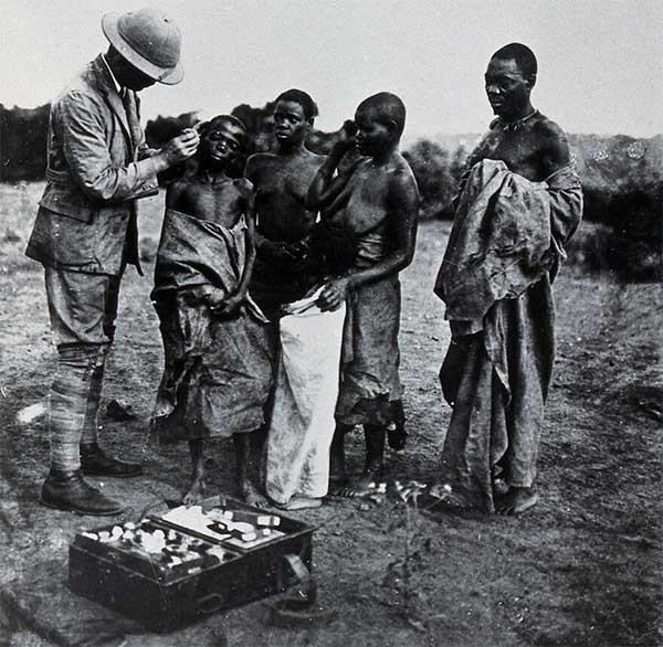A medical officer taking a sample of blood from an inhabitant of Buruma Island, suffering from sleeping sickness. Photograph, 1965, after photograph 1902. Wellcome Collection. Source: Wellcome Collection.
