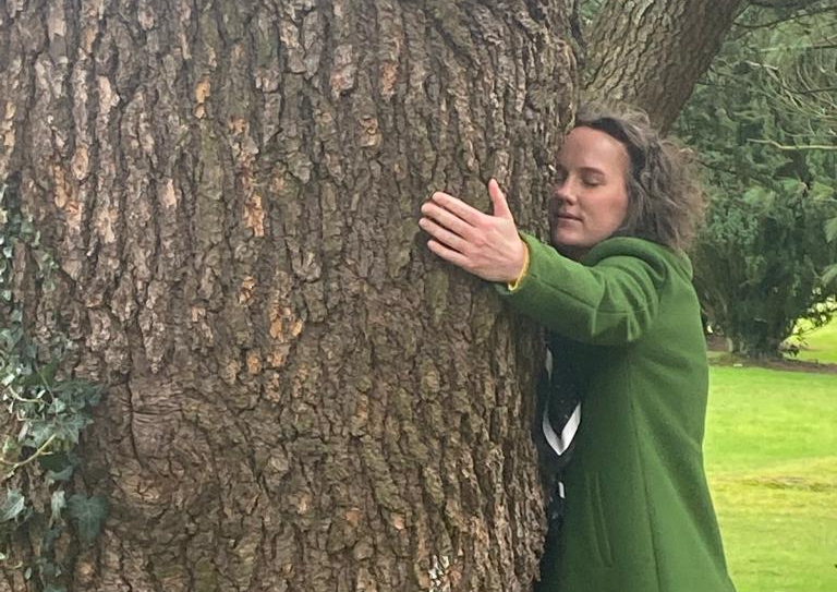 Katherine Twomey hugging a tree