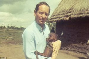 Michael Buerk pictured with child famine sufferer in 1984 BBC News report