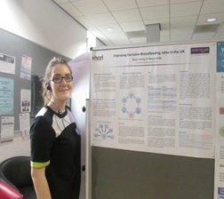 Rosie Conroy in front of her poster presentation on exclusive breastfeeding