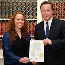 Dr Hughes receiving award from David Cameron for volunteer work in fight against Ebola