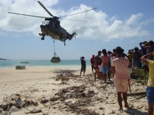 helicopter dropping load on a beach