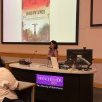 Photo of Prof Nida Kirmani with screen behind