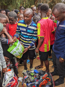 Men distributing football boots 