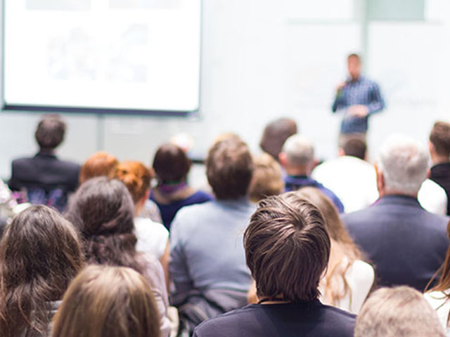 Speaker giving a talk at a meeting.