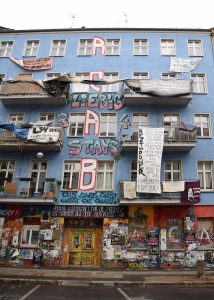 An apartment block with graffiti