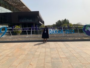 Chantal standing in front of World Water Forum sign in the sun