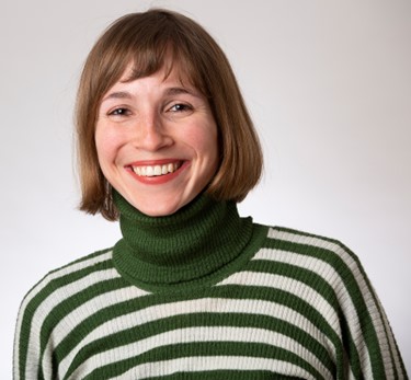 A woman with a green and white stripy top and brown hair