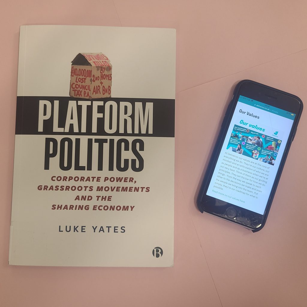 A book "Platform Politics: Corporate Power, Grassroots Movements, and the Sharing Economy" by Luke Yates with a smartphone displays a webpage with the heading 'Our Values' of a platform-based organisation Deliveroo