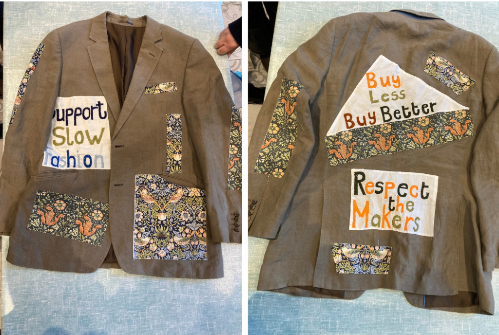 Upcycled linen jacket with patchwork and embroidery, featuring messages like "Support Slow Fashion," "Buy Less, Buy Better," and "Respect the Makers."